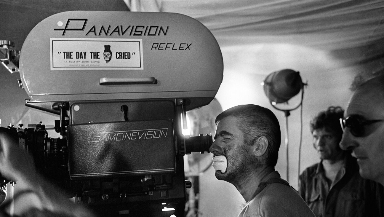 Jerry Lewis (L) looks through the camera on March 22, 1972, during the shooting of the film “The Day the Clown Cried.” (STF/AFP via Getty Images)