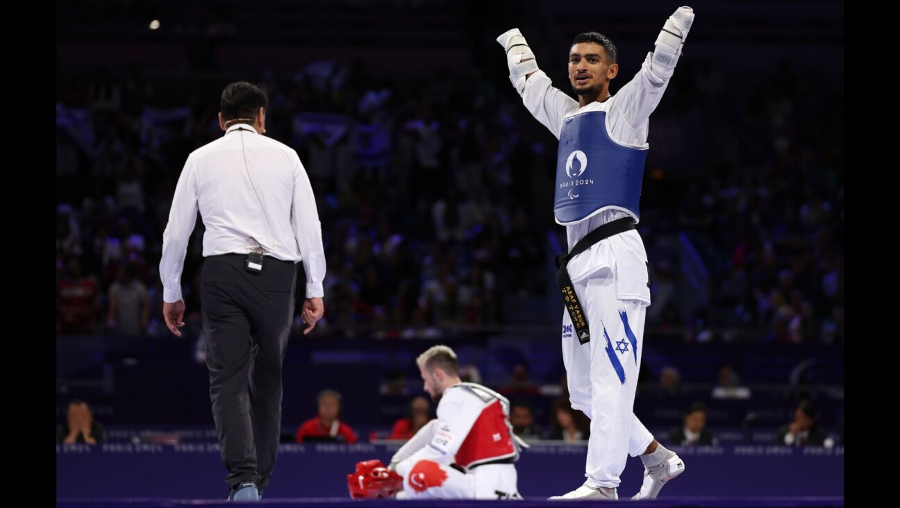 Asaf Yasur celebrates victory against Ali Can Ozcan of Turkey in the men's K44 - 58-kilogram gold medal contest at the 2024 Paris Summer Paralympic Games, Aug. 29, 2024, in Paris. (Steph Chambers/Getty Images)