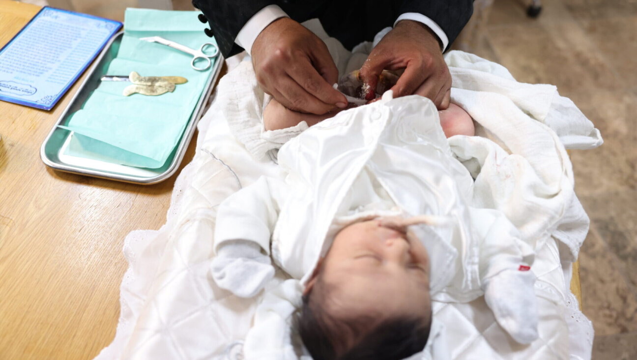 A mohel performs a circumcision ceremony in Israel, July 6, 2023. (David Cohen/Flash 90)