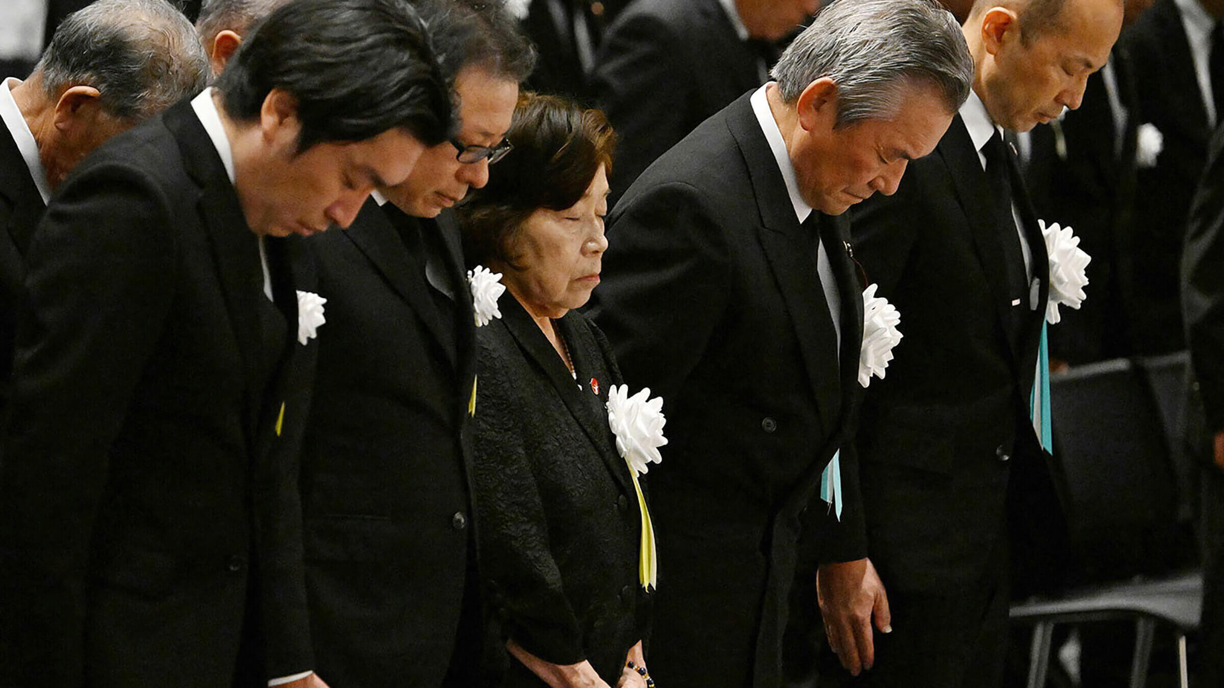 Eighty-five-year-old atomic bombing survivor Takeko Kudo (3rd L) and other representatives observe a moment of silence at the time of the bombing at 11:02am during a peace memorial ceremony in Nagasaki.