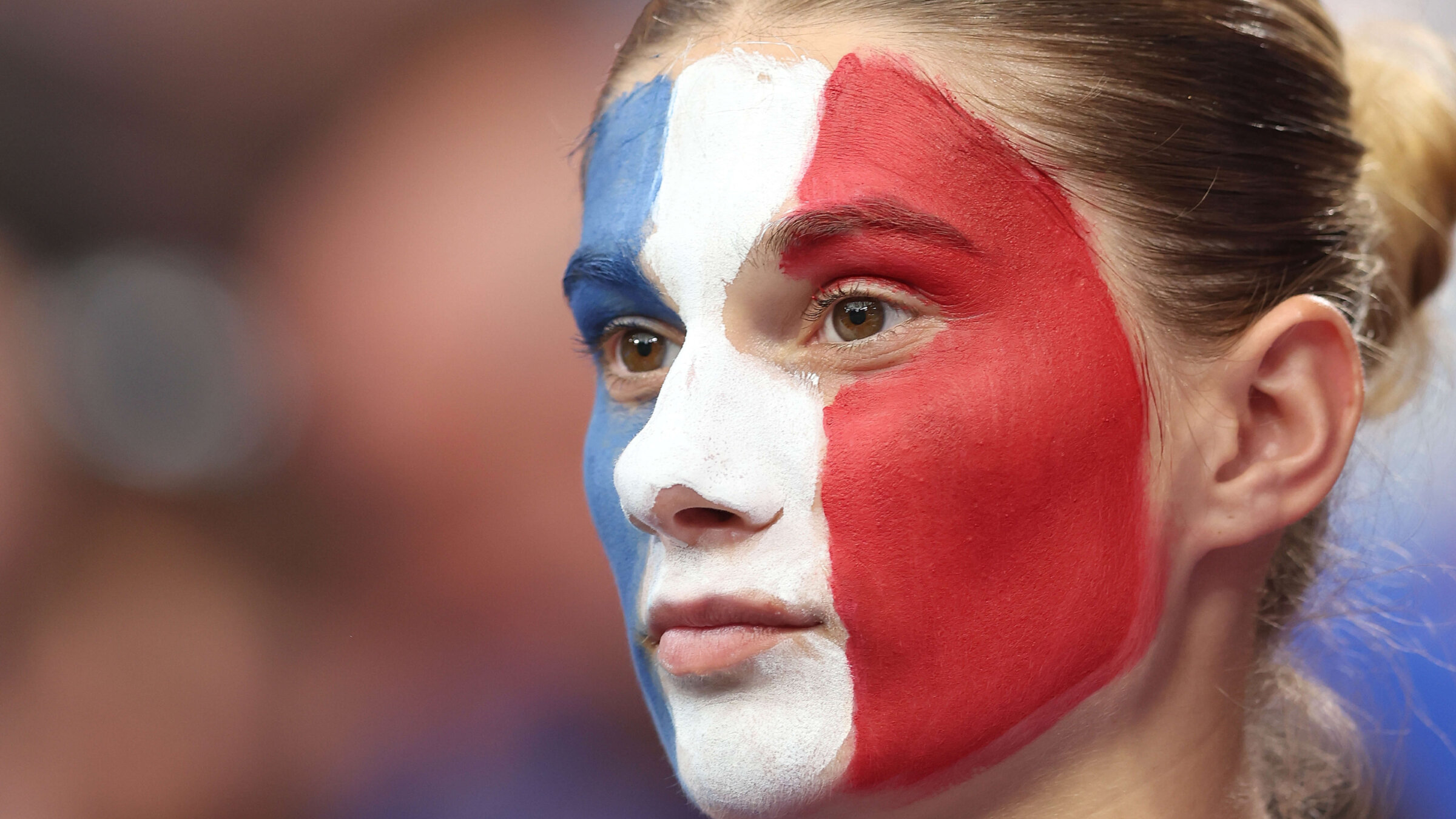 A French sports fan displays her national pride.