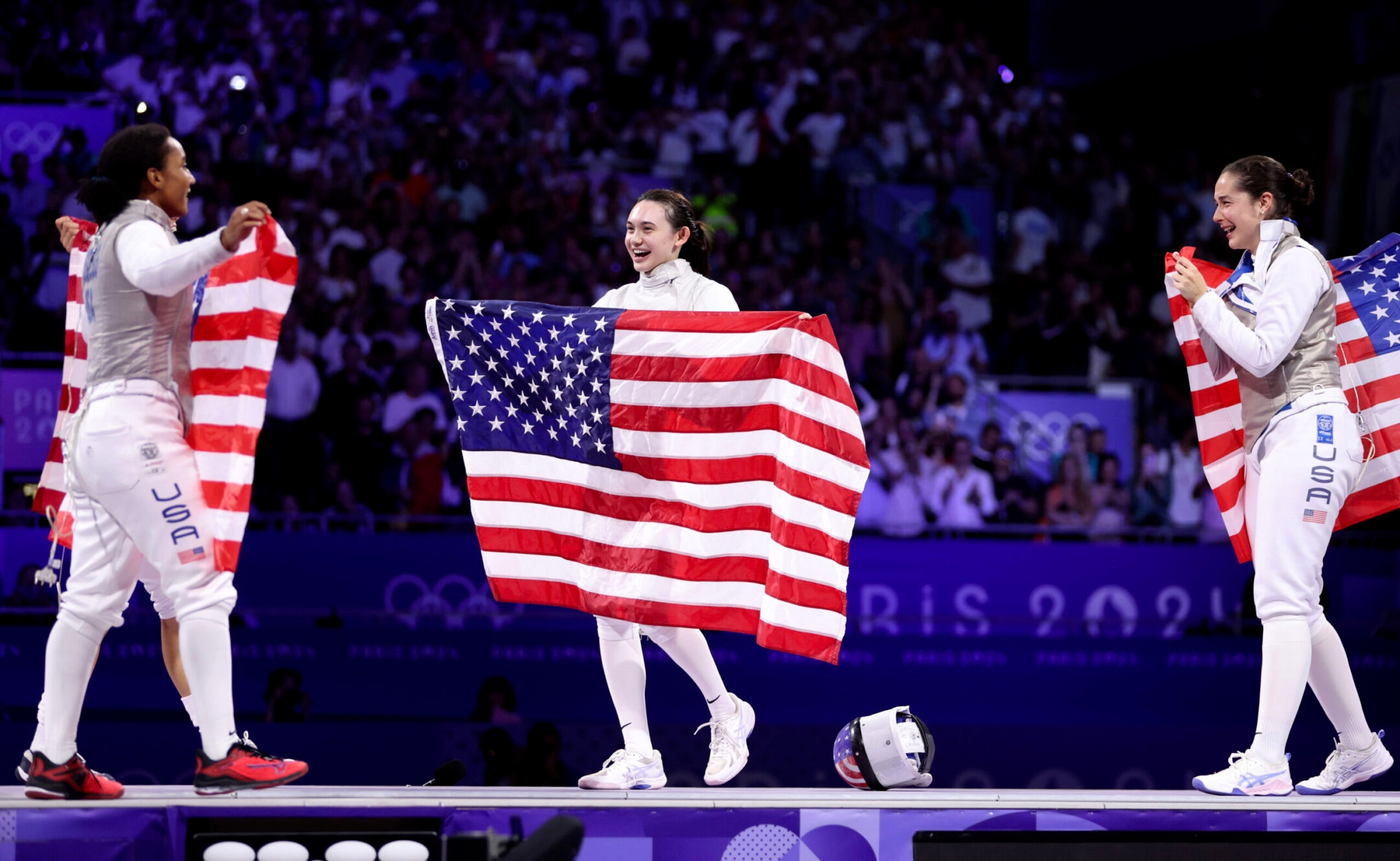 Lauren Scruggs, Maia Weintraub and Jackie Dubrovich of Team United States celebrate winning against Italy during the fencing women’s foil team gold medal match at the Paris Olympics, Aug. 1, 2024.(Clive Brunskill/Getty Images)