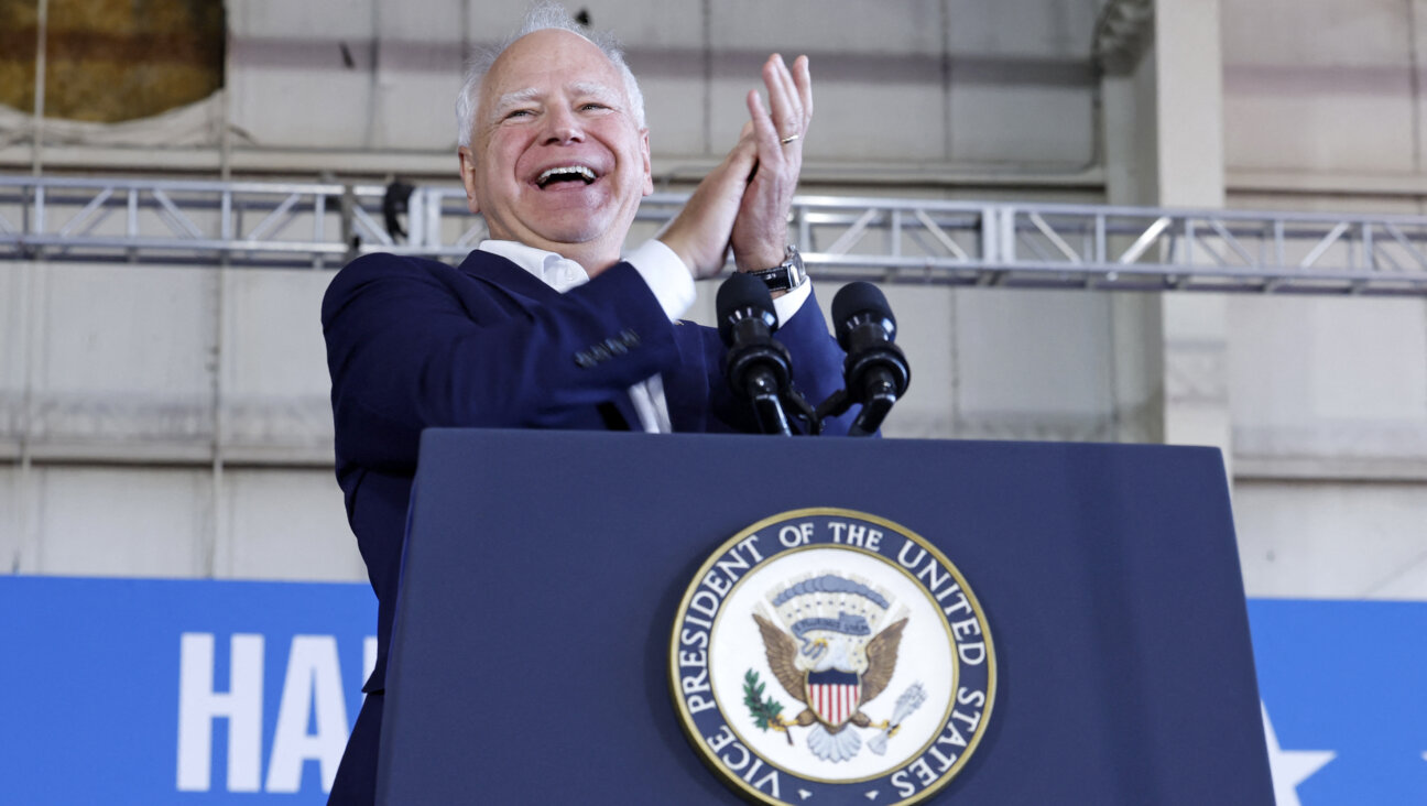 Tim Walz speaks during a campaign rally at Detroit Metropolitan Airport in Romulus, Michigan.