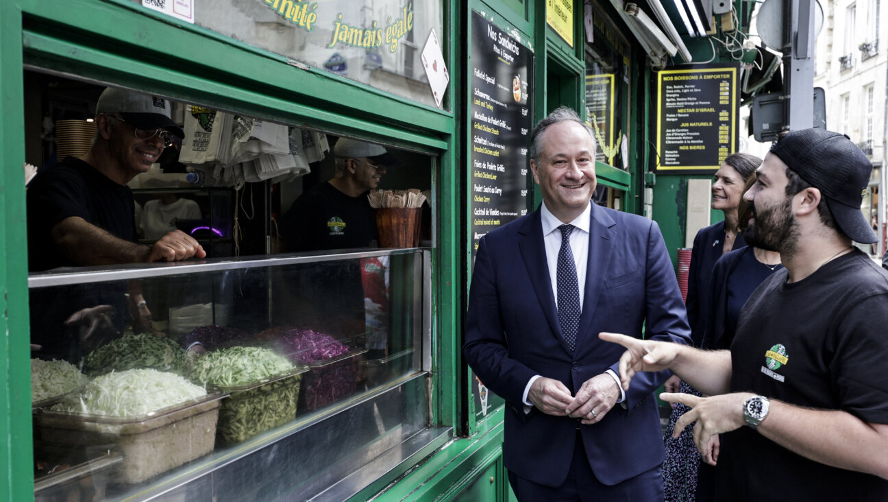 US second gentleman Doug Emhoff speaks with the employee of a restaurant at the site of a deadly 1982 antisemitic attack.