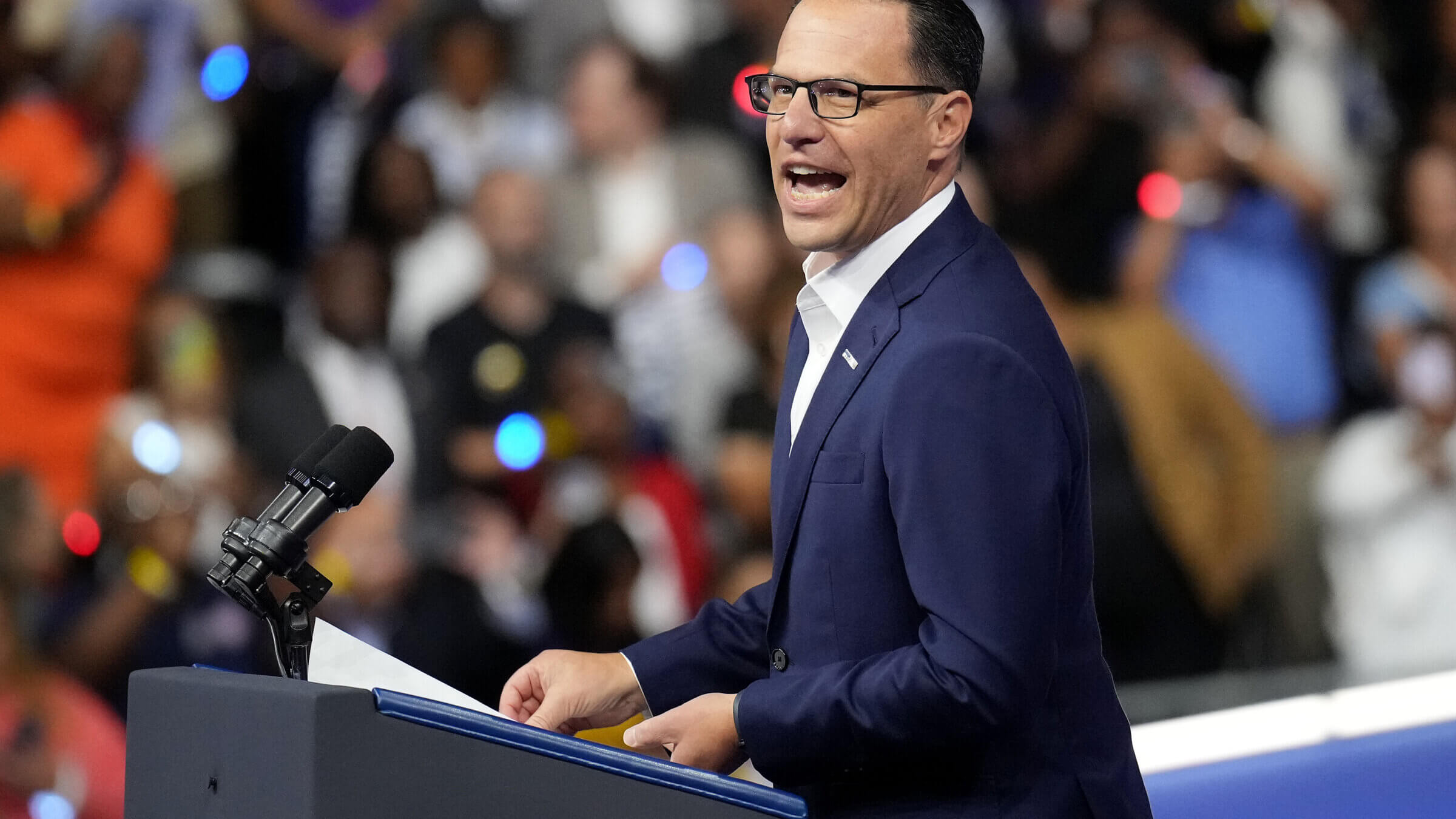 Pennsylvania Gov. Josh Shapiro greets the crowd before the start of a campaign rally with Democratic presidential candidate Kamala Harris and vice presidential candidate Tim Walz Aug. 6 in Philadelphia.