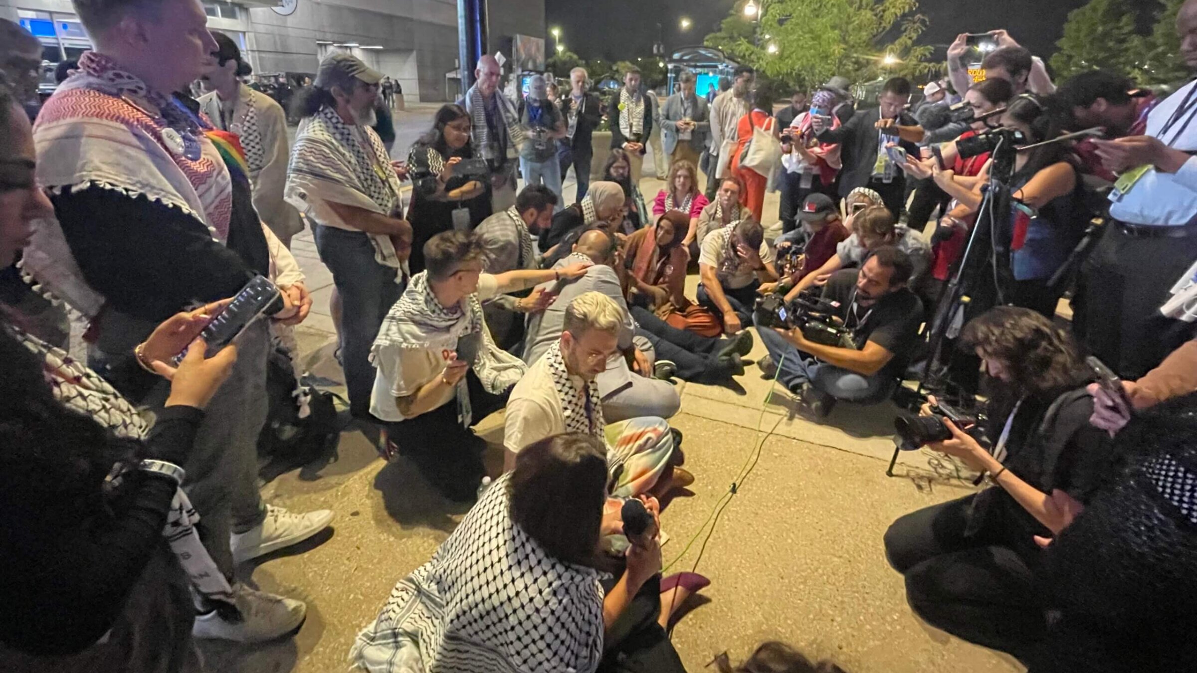 "Uncommitted" delegates to the Democratic National Convention staged a sitin outside the United Center Wednesday night to demand a Palestinian-American be allowed to speak from the main stage. 