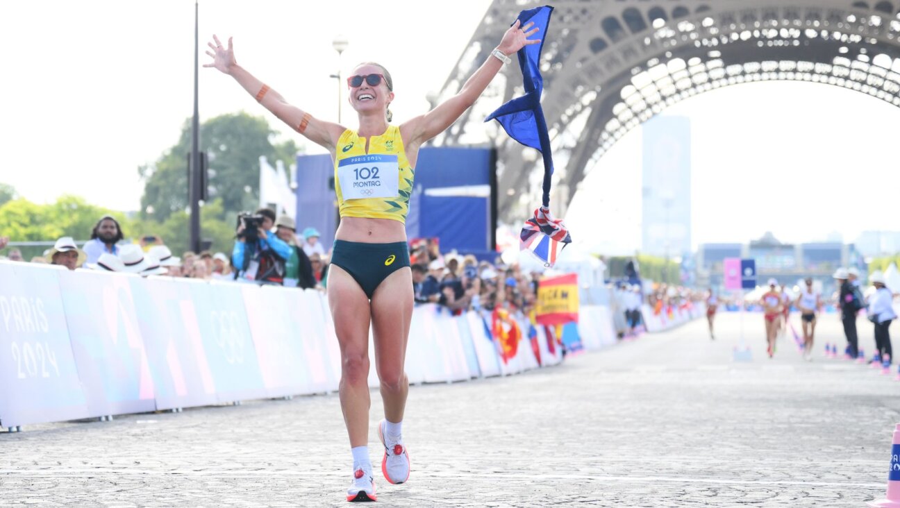 Jemima Montag celebrates after crossing the finish line during the mixed marathon racewalk relay at the 2024 Paris Olympics, Aug. 7, 2024, in Paris. (David Ramos/Getty Images)