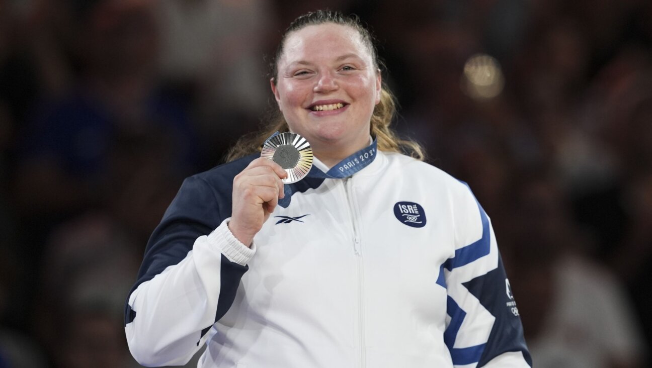 Raz Hershko celebrates on the podium at the 2024 Paris Olympics, Aug. 2, 2024, in Paris. (Mustafa Ciftci/Anadolu via Getty Images)