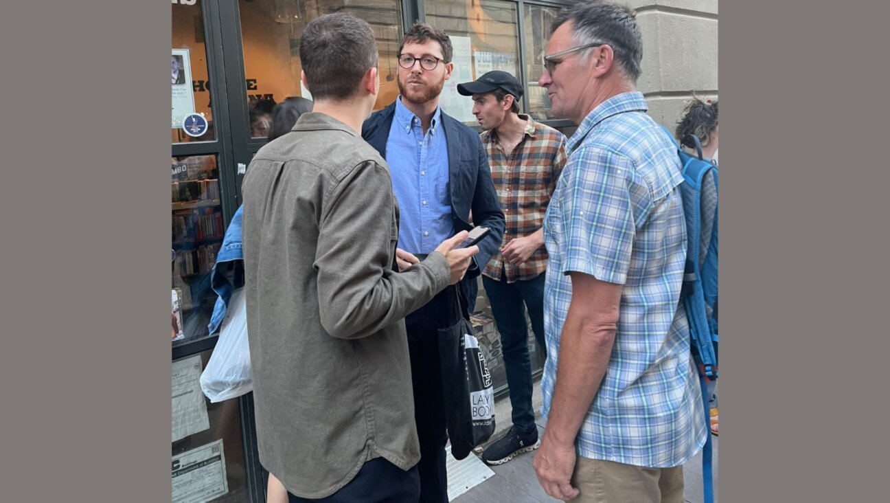 Joshua Leifer, center, with Rabbi Andy Bachman, right, outside Powerhouse Arena after an event for Leifer's book was canceled.