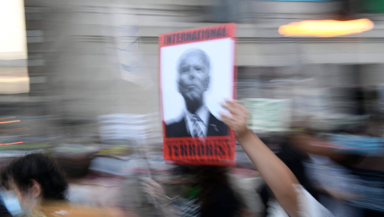 A protester holds a sign reading "International terrorist" with a portrait of President Joe Biden during a protest to demand reproductive justice, defend the rights of trans and queer people and demand a ceasefire in Gaza on the eve of the Democratic National Convention, Chicago, on Aug. 18. 