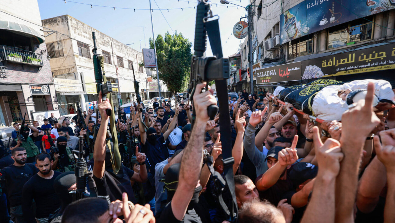 Relatives and gunmen attend the funeral of five Palestinians killed in an Israeli strike in Jenin in the occupied West Bank, Aug. 6.