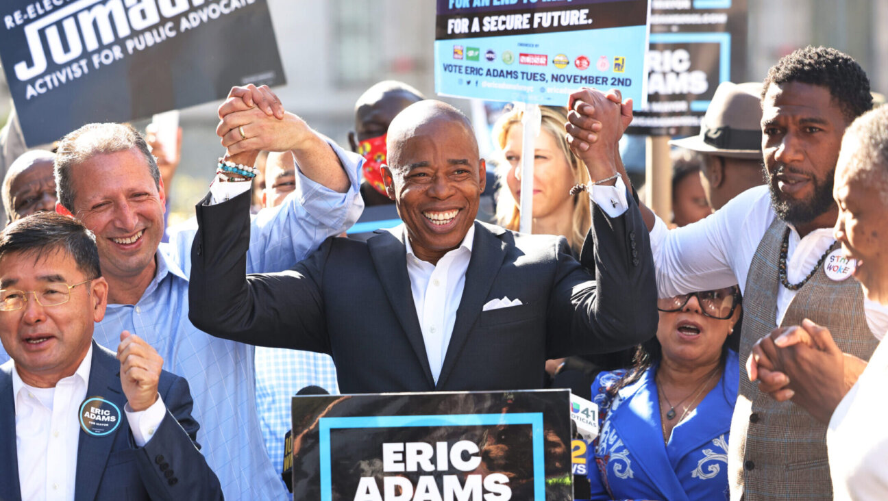 Eric Adams, center, campaigns with Brad Lander, left, and Jumaane Williams outside Brooklyn Borough Hall, Oct. 22, 2021. (Michael M. Santiago/Getty Images)