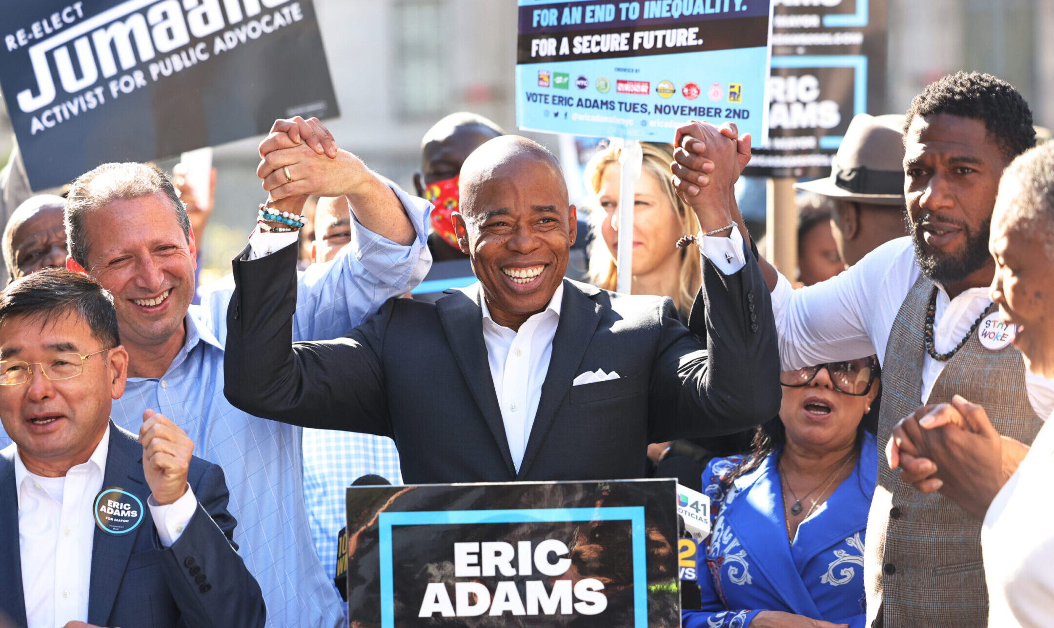 Eric Adams, center, campaigns with Brad Lander, left, and Jumaane Williams outside Brooklyn Borough Hall, Oct. 22, 2021. (Michael M. Santiago/Getty Images)