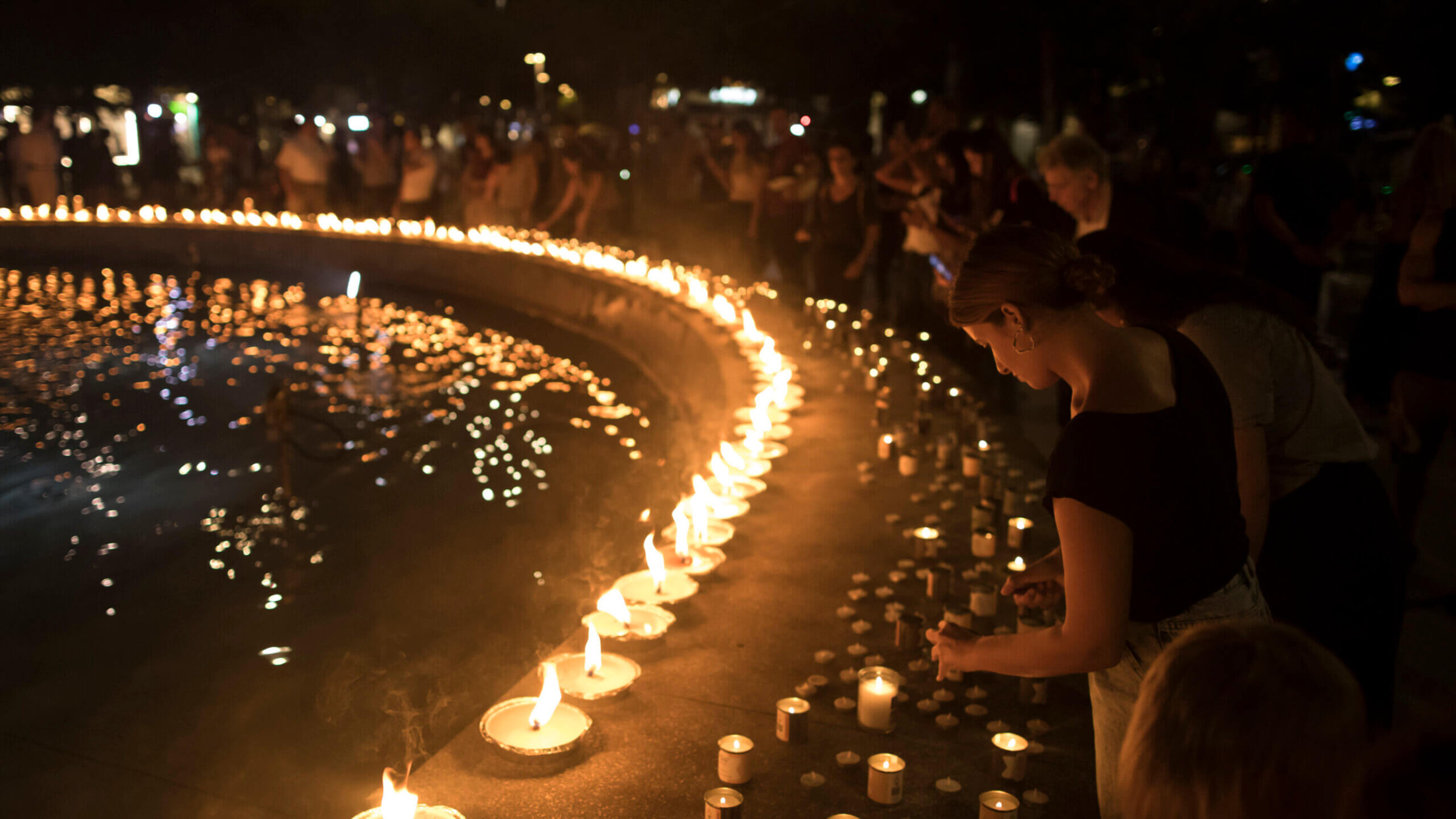 People light candles in memory of the civilians and soldiers killed during the Oct. 7, 2023 Hamas attack on Israel. 