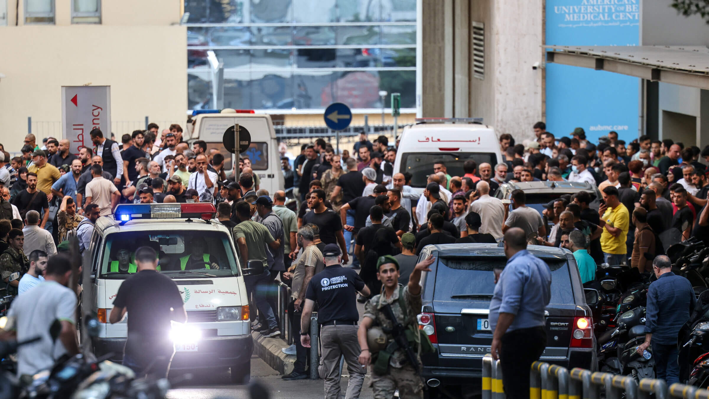 Ambulances are surrounded by people at the entrance of the American University of Beirut Medical Center after paging devices exploded in Lebanon. 