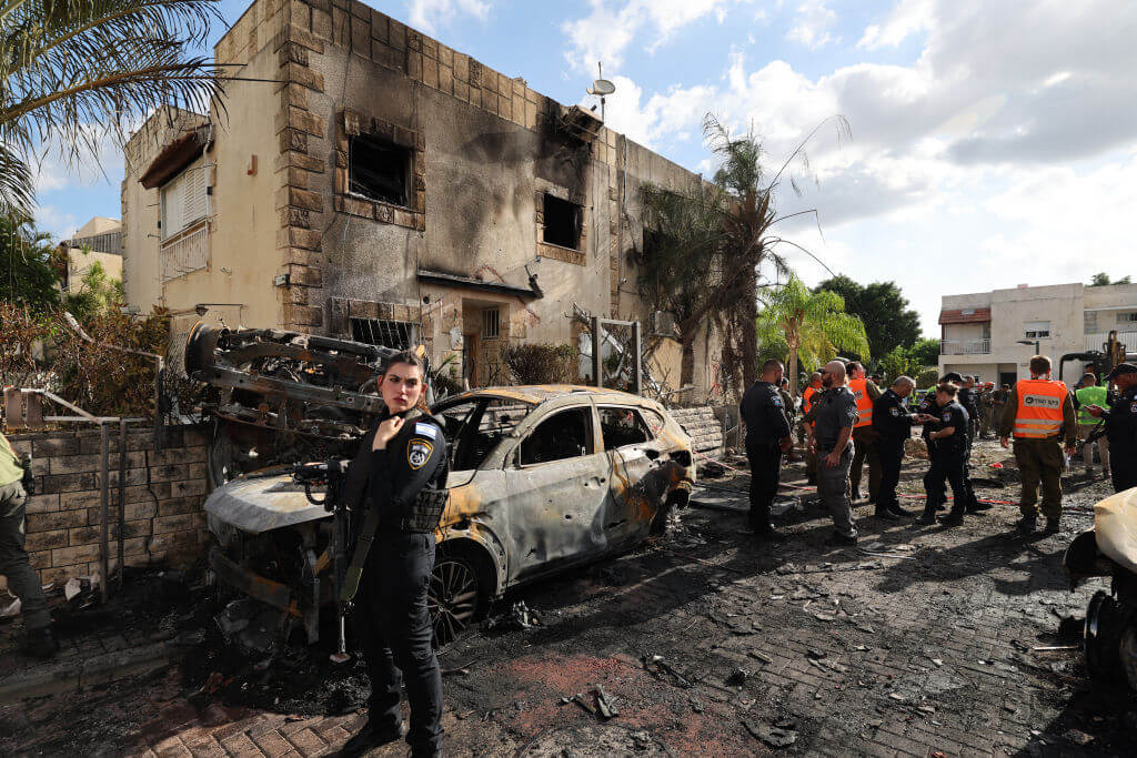 First responders and Israeli security forces gather amid debris and charred vehicles in Kiryat Bialik in the Haifa District of Israel, following a reported strike by Lebanon's Hezbollah on September 22.