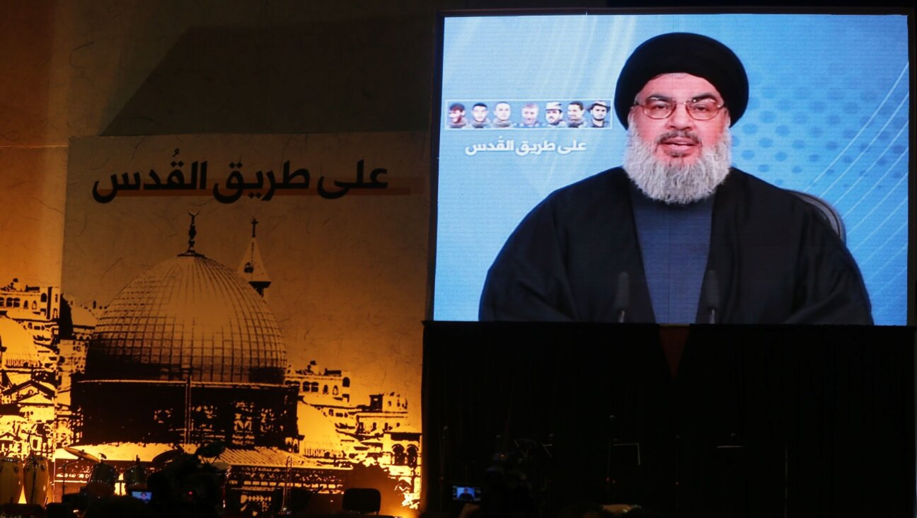 Hassan Nasrallah, the head of Hezbollah whom Israel killed in a Friday airstrike, addressed supporters via a giant screen in Beirut in 2014. 