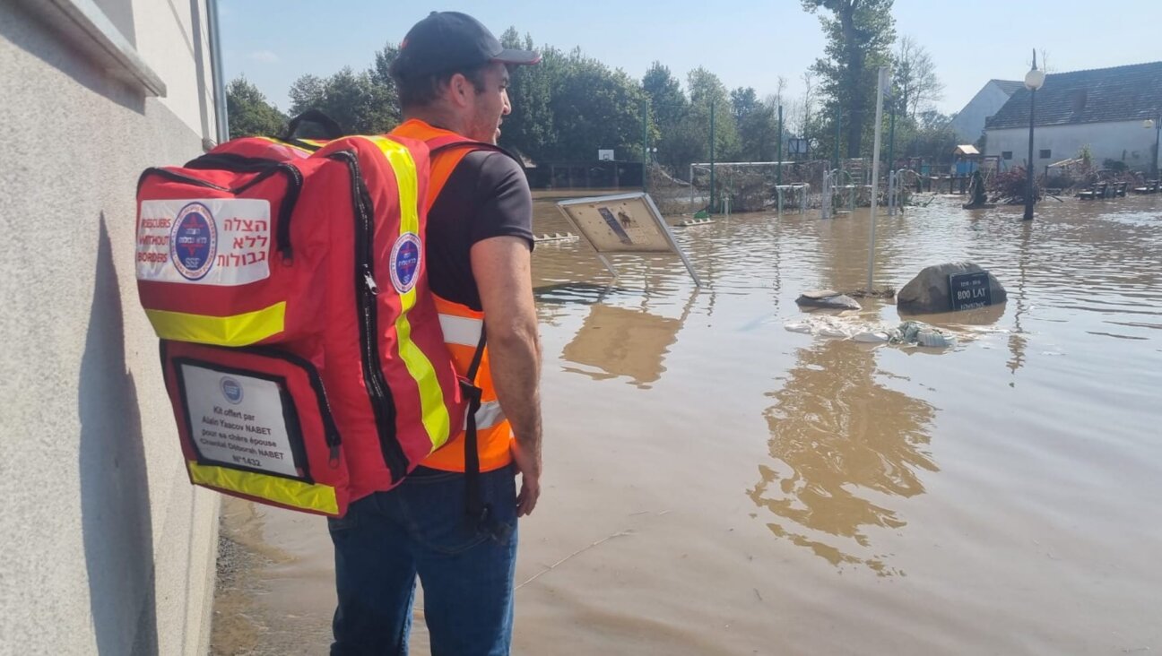 An Israeli volunteer with Rescuers without Borders gazes over floodwaters in Poland, Sept. 18, 2024. (Courtesy Michael Schudrich)