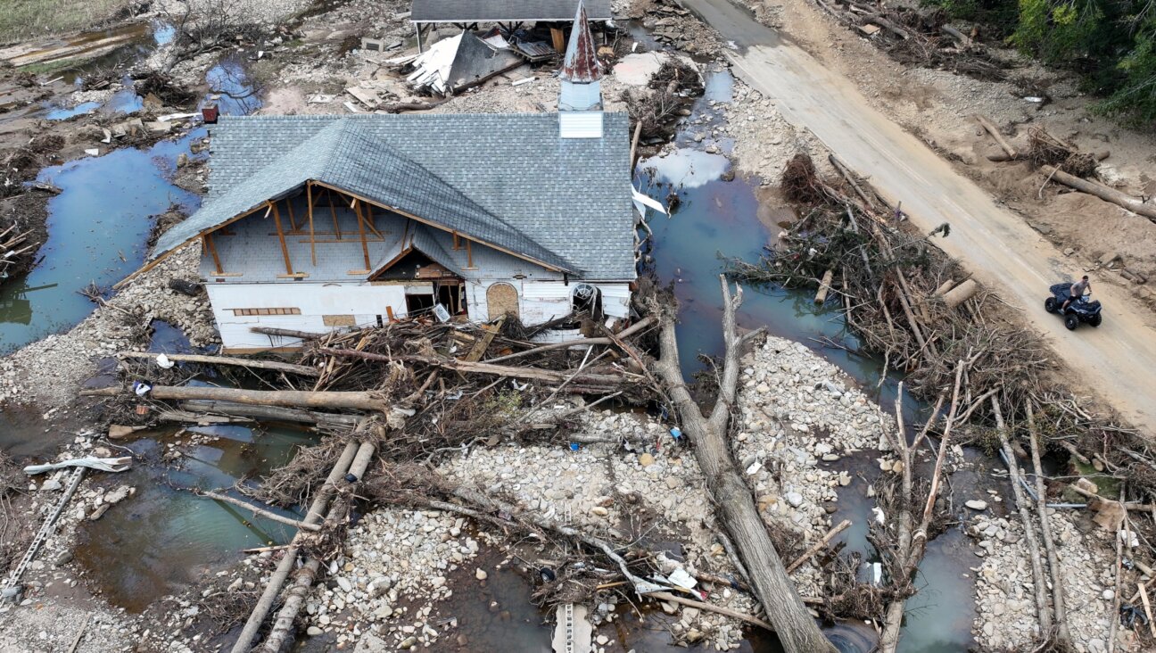 In an aerial view, a person rides past a destroyed church in the aftermath of Hurricane Helene flooding, Swannanoa, North Carolina, Oct. 6, 2024 .(Mario Tama/Getty Images)