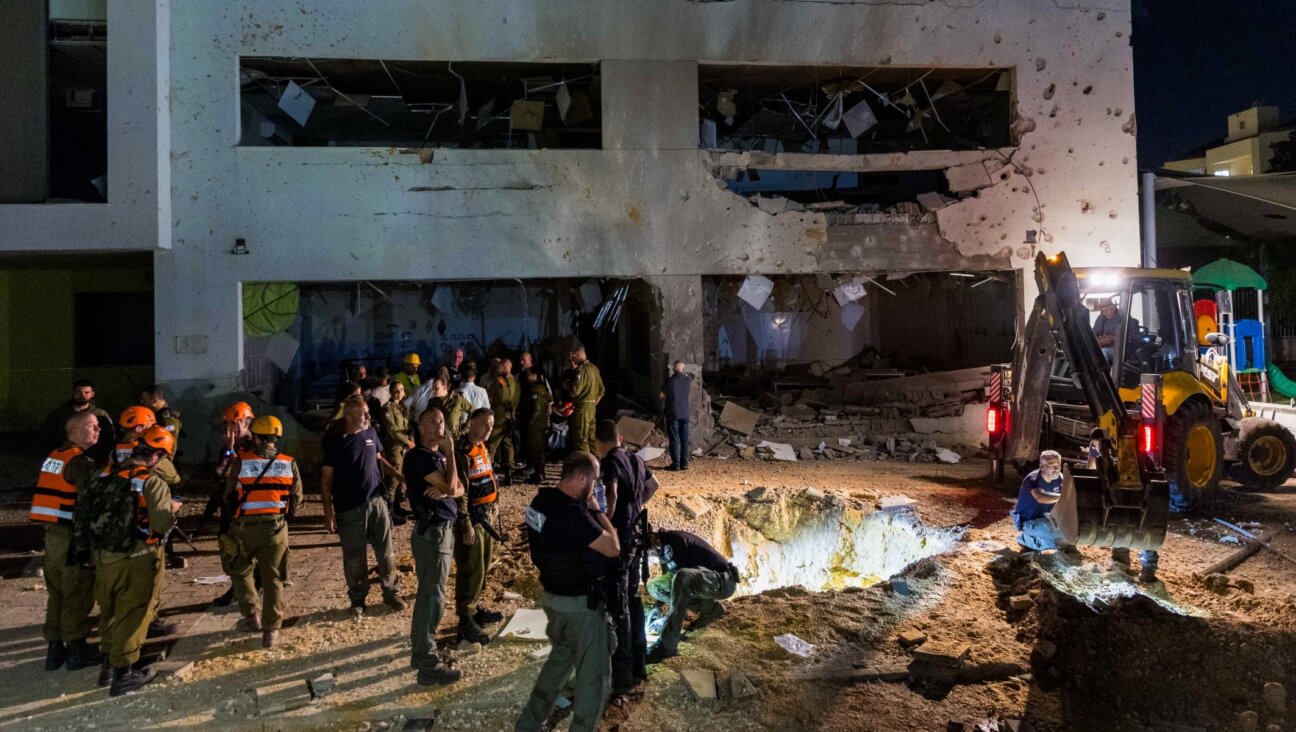 Israeli security forces at the scene where a missile fired from Iran hit a school in the town of Gedera, Oct. 1, 2024. (Liron Moldovan/Flash90)