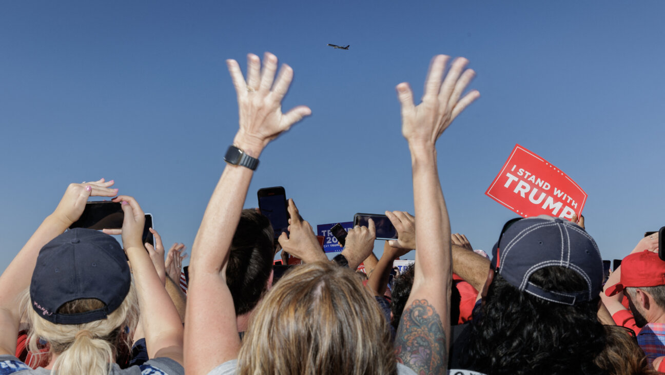 Supporters of former US President Donald Trump cheer as his plane flies over the 2024 election campaign rally in Waco, Texas in 2023.