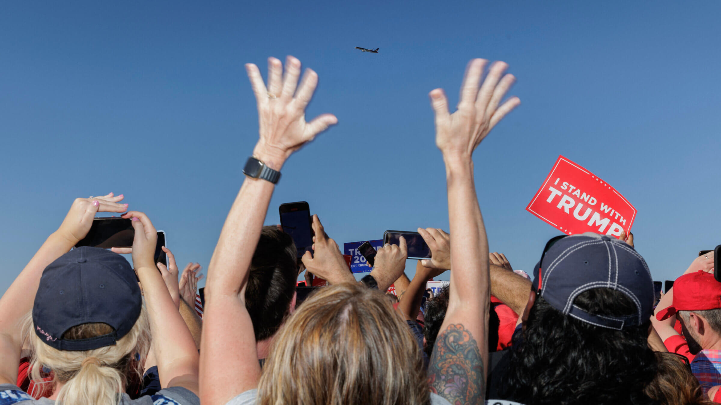 Supporters of former US President Donald Trump cheer as his plane flies over the 2024 election campaign rally in Waco, Texas in 2023.