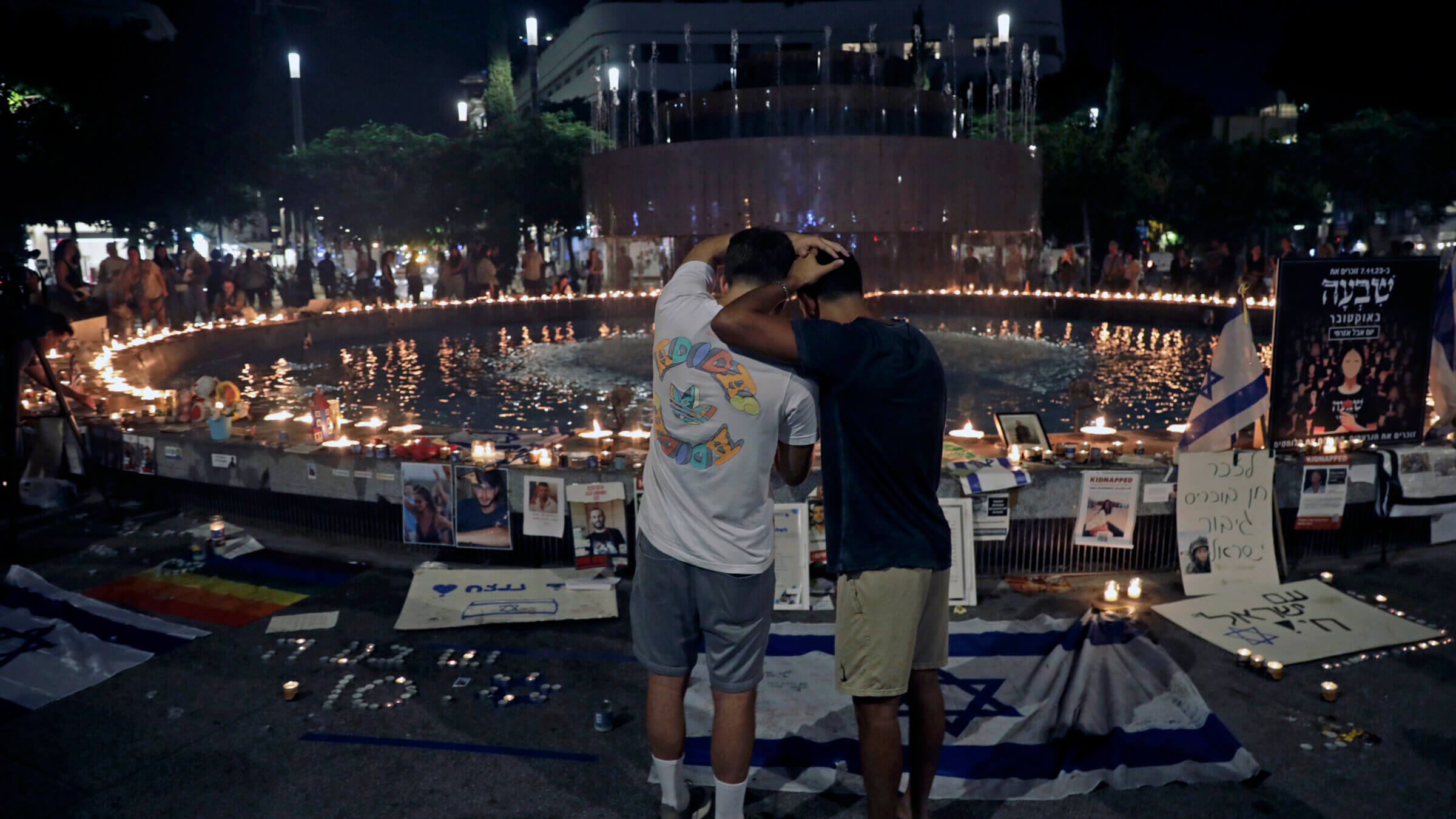 People attend a candle-light vigil as a tribute to the people killed and kidnapped in the October 7th attacks around the fountain in Dizengoff Square on November 07, 2023 in Tel Aviv, Israel. 