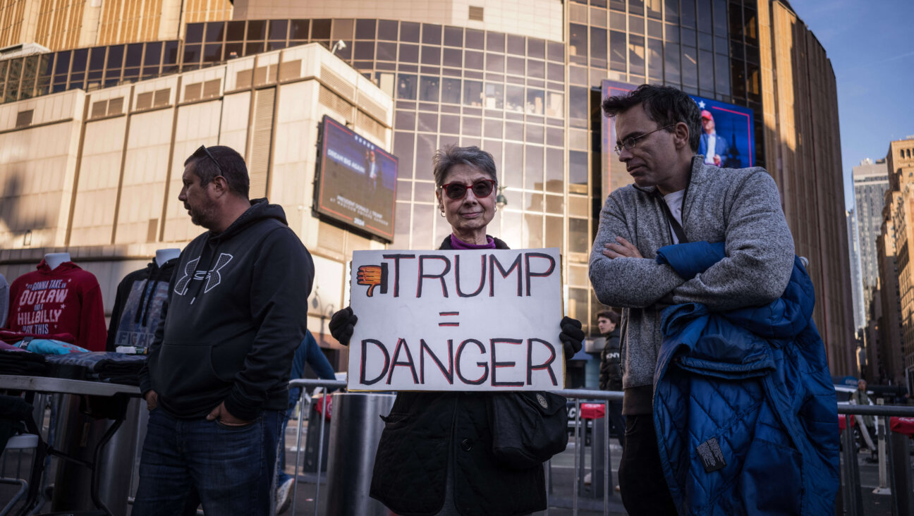 A demonstrator holds a "Trump = Danger" sign during a "Resist Facism" protest as former US President and Republican presidential candidate Donald Trump holds a campaign rally at Madison Square Garden in New York, October 27, 2024.