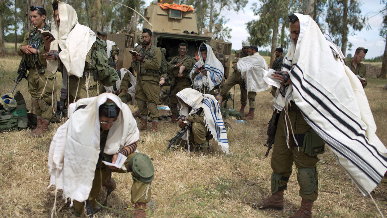 Israeli soldiers of the Jewish ultra-Orthodox battalion Netzah Yehuda hold morning prayers as they take part in their annual unit training in the Golan Heights on May 19, 2014. Many Netzah Yehuda recruits come from the Hardal sector.