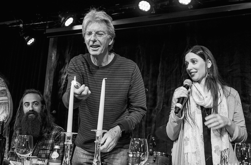 Phil Lesh lights the candles as Jeannette Ferber, a cantorial soloist at Berkeley’s Renewal congregation Chochmat HaLev, sings the blessing, and guitarist Ross James looks on. (© Bob Minkin Photography / www.minkinphotography.com)