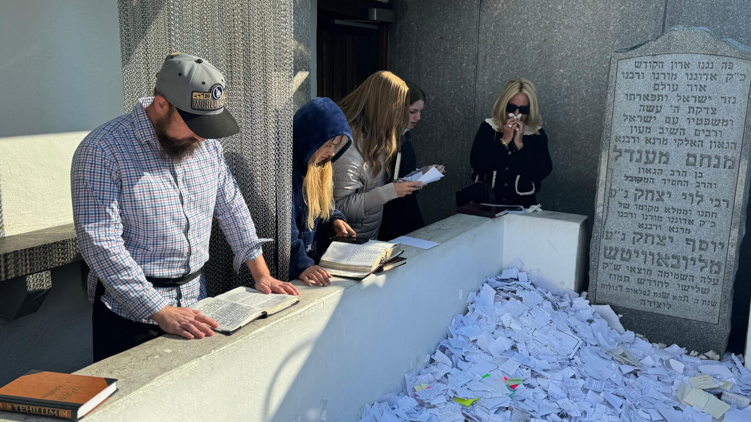 Reuven Kasten, left, at the gravesite of Rabbi Menachem Mendel Schneerson.