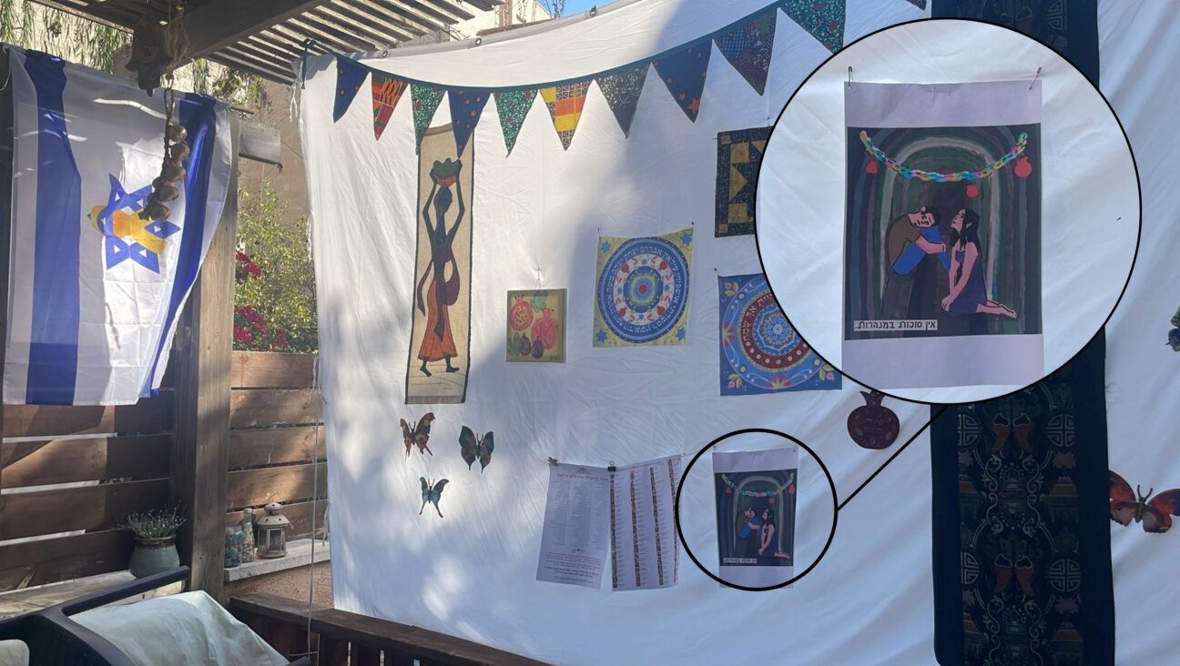 Jessica Steinberg printed and displayed in her Sukkah an Instagram post from a famous Israeli illustrator, Zeev Engelmayer, that shows two Israeli hostages observing Sukkot in a Hamas tunnel.