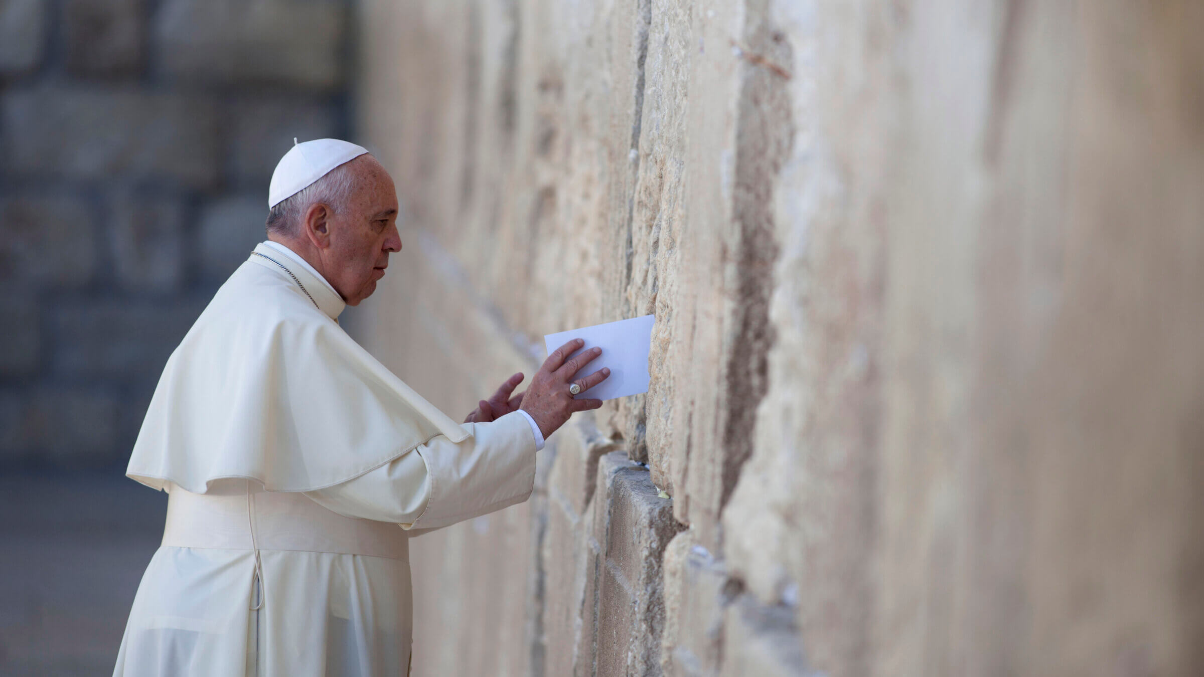 Pope Francis places a prayer into the Western Wall on May 26, 2014 in Jerusalem.