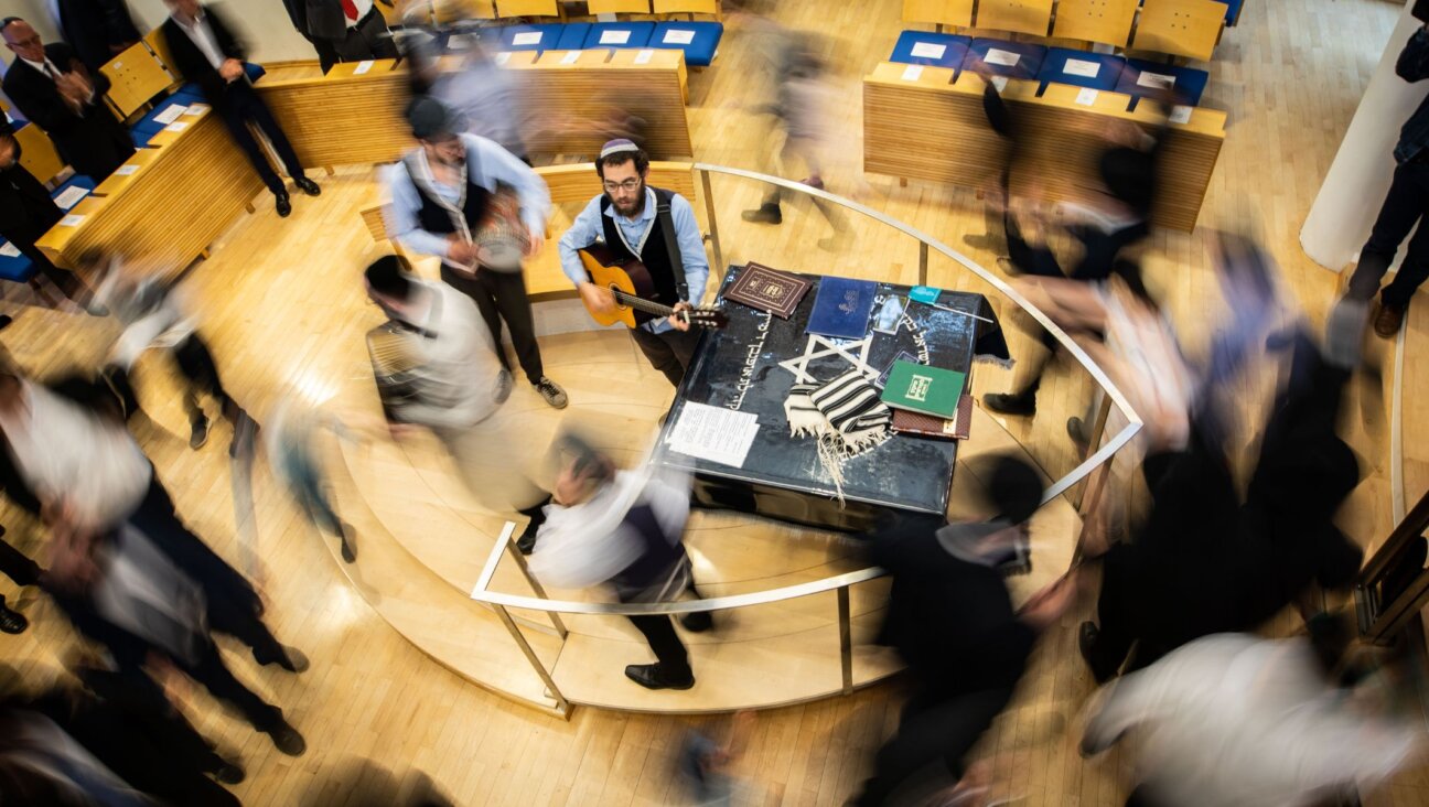 Hakafot — circular dances around the Torah — are a key ritual on the holiday of Simchat Torah. (Frank Rumpenhorst/picture alliance via Getty Images)