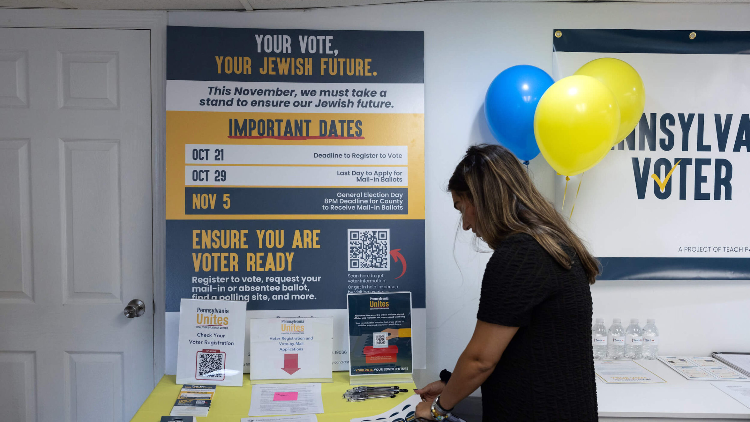 A woman takes a sticker at a Jewish Get Out The Vote center opened by Pennsylvania Unites in Merion Station, Pennsylvania, on Sept. 17.