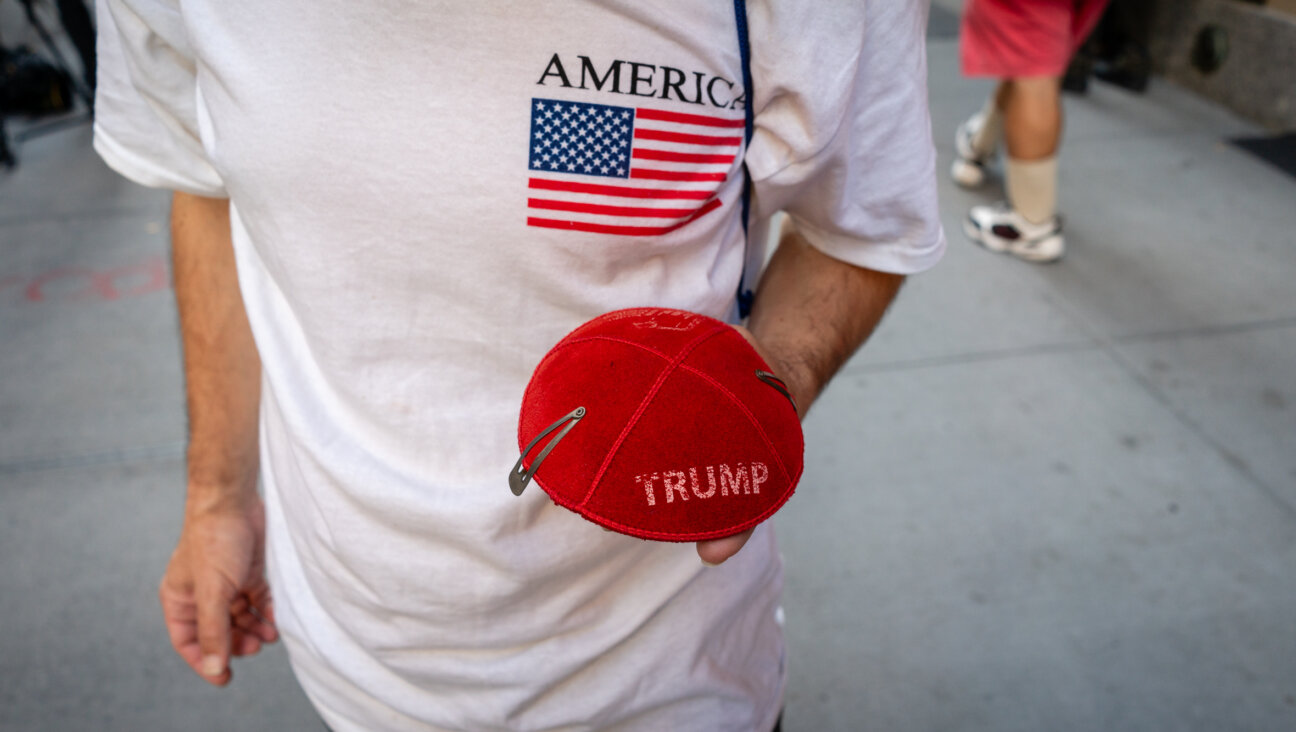 Ariel Kohane, a supporter of Donald Trump, holds a Trump kippah in front of Trump Tower in midtown Manhattan, Nov. 6, 2024. (Luke Tress)