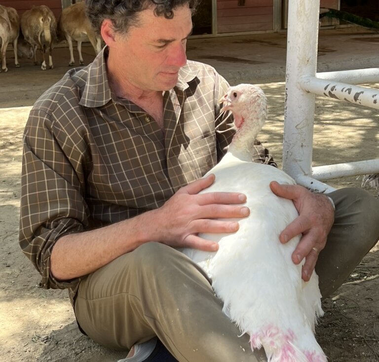 Rob Eshman hugging Justice the turkey at Gentle Barn in Santa Clarita, Calif.