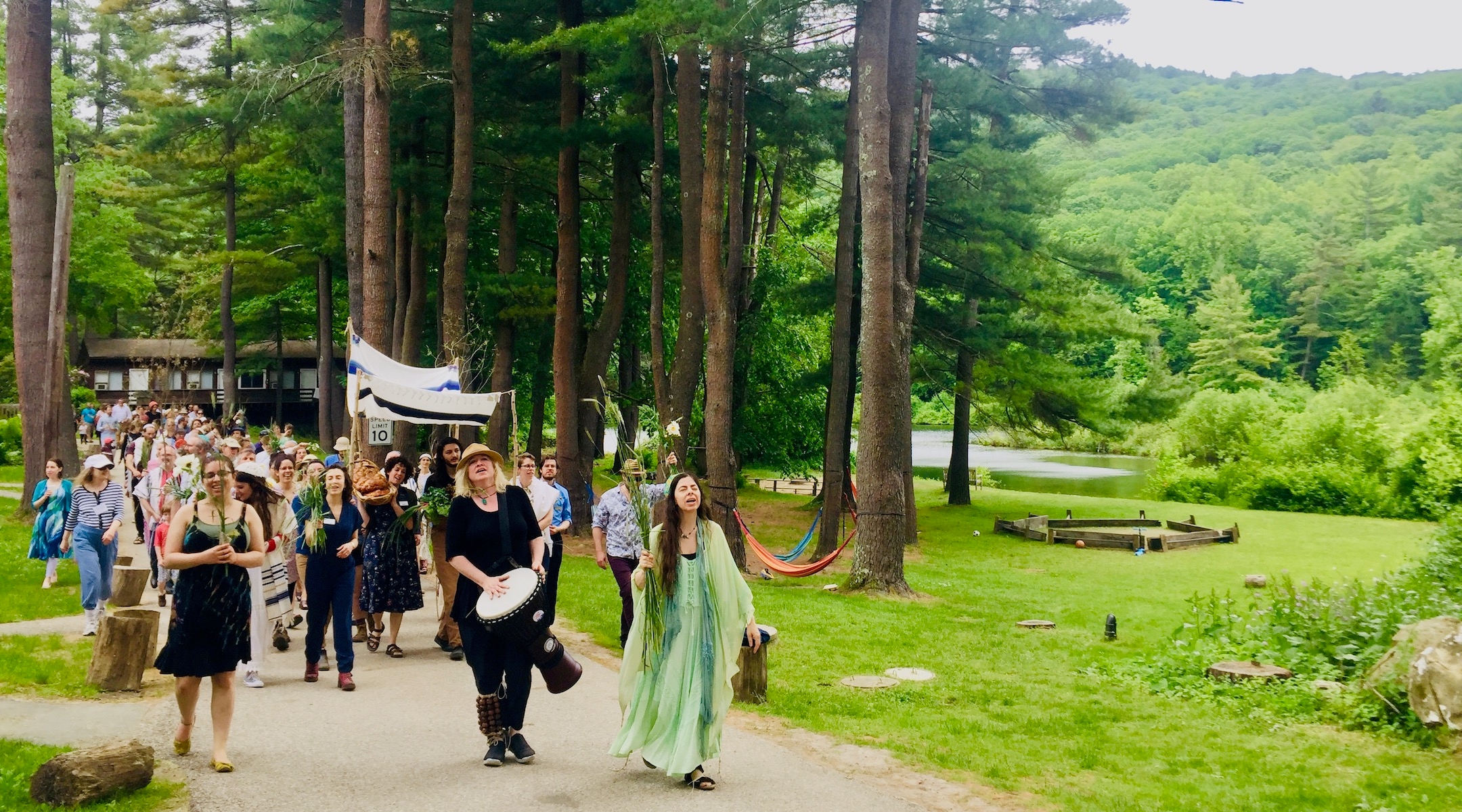 A Shavuot parade at the Isabella Freedman Jewish Retreat Center, a Hazon-operated complex in Falls Village, Conn. Hazon is merging with the Pearlstone Center outside Baltimore to create a combined Jewish environmental group budgeted at $12 million. (Courtesy of Pearlstone)