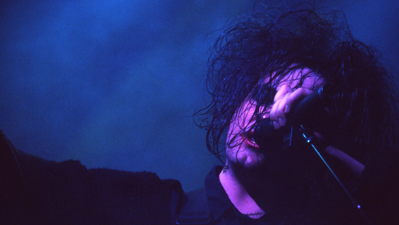 Robert Smith performs with The Cure.