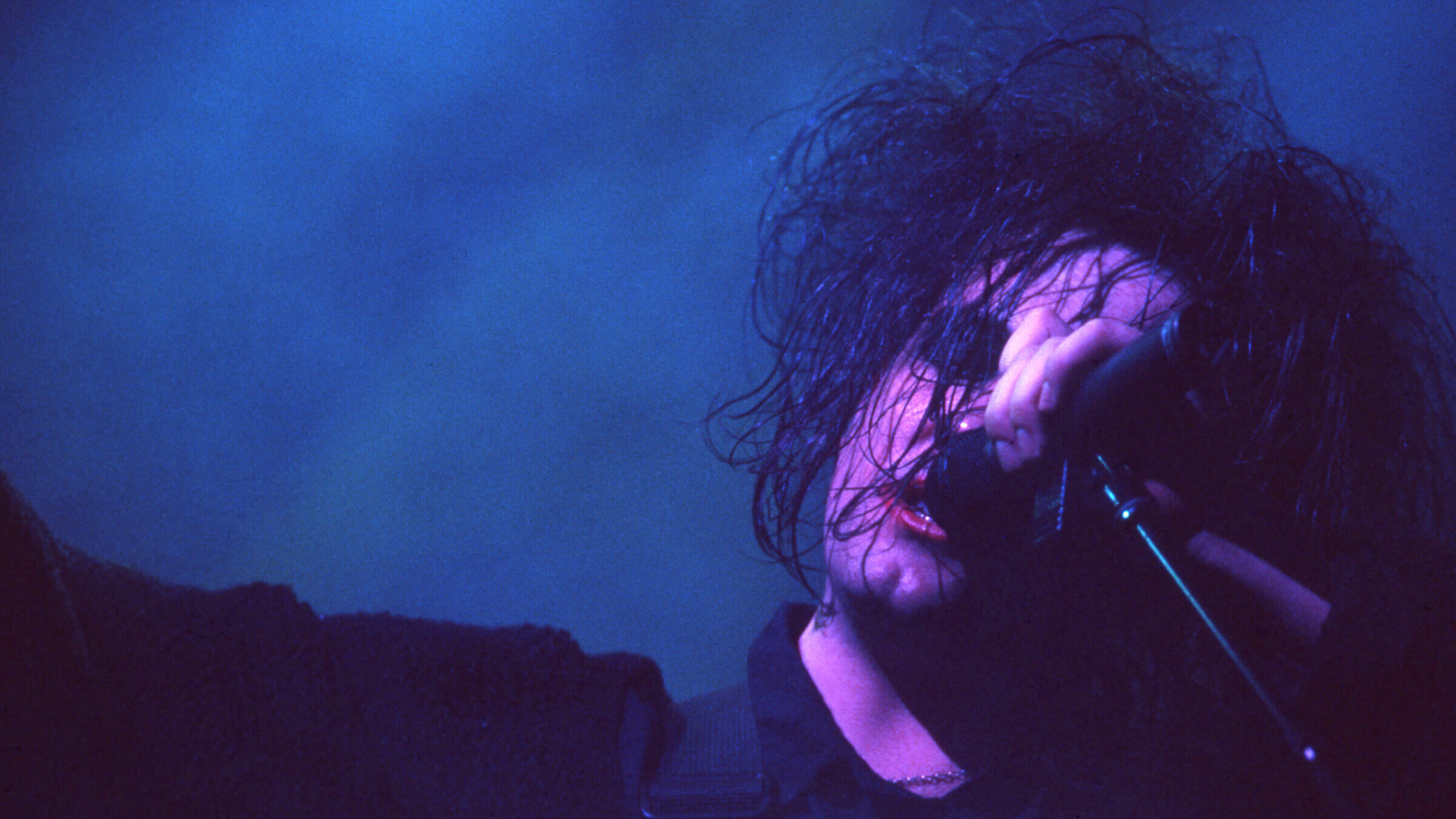 Robert Smith performs with The Cure.