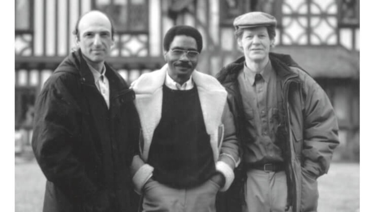 Commune members Sam Chaiton and Terry Swinton with Rubin “Hurricane” Carter outside the commune’s mansion in the King City section of Toronto.