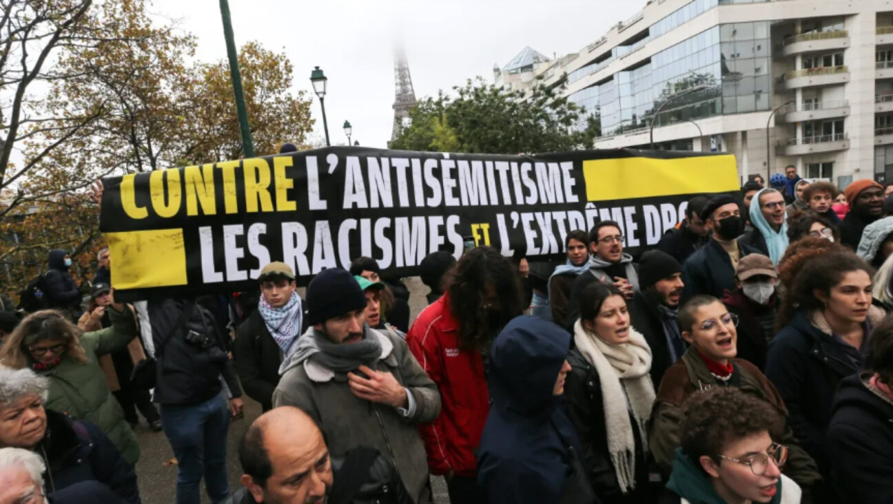 Demonstrators carry a banner reading "Against antisemitism, racism and the extreme right" during a rally at the Square des Martyrs Juifs in Paris, Nov. 12, 2023