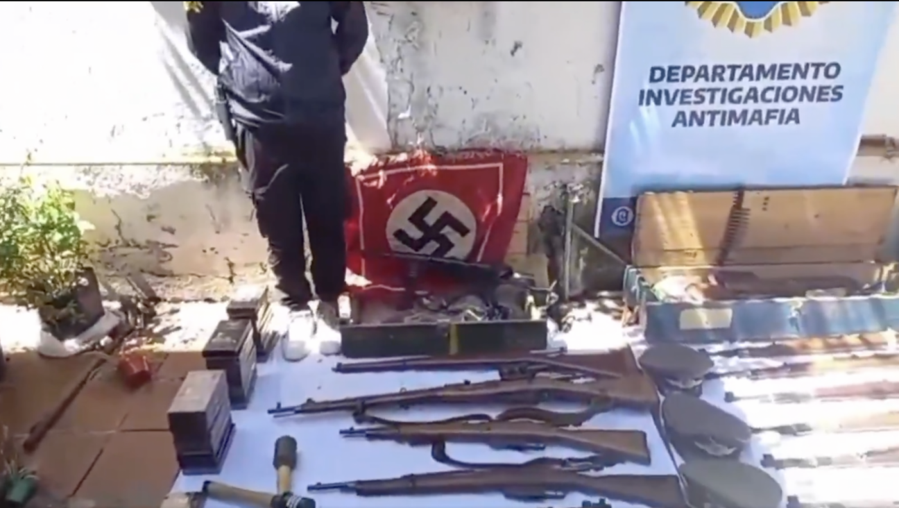 Argentine police show off what they said were Nazi guns and memorabilia seized in a November 2024 raid. (Screenshot)