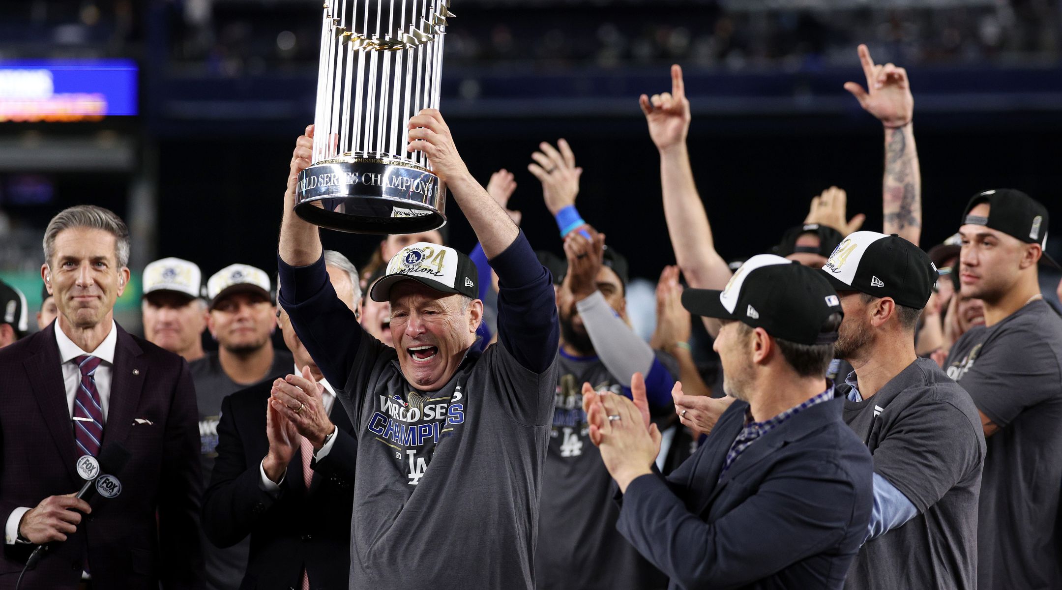 Stan Kasten, president and CEO of the Los Angeles Dodgers, celebrates with the Commissioner’s Trophy after defeating the New York Yankees in the 2024 World Series, Oct. 30, 2024, in New York City. (Elsa/Getty Images)