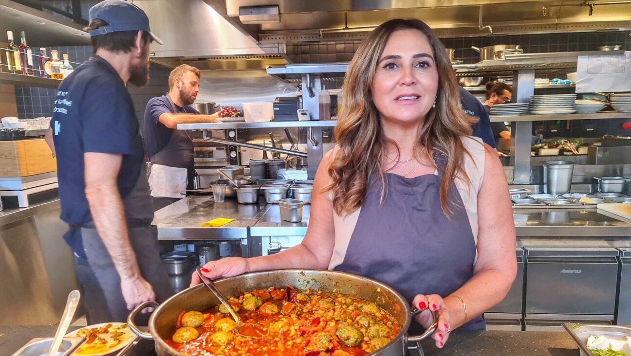 Sharona Dahan cooks at Asif in Tel Aviv, in a rare respite from takeout nearly a year after being evacuated from her home in Sderot, October 2024. (Deborah Danan)