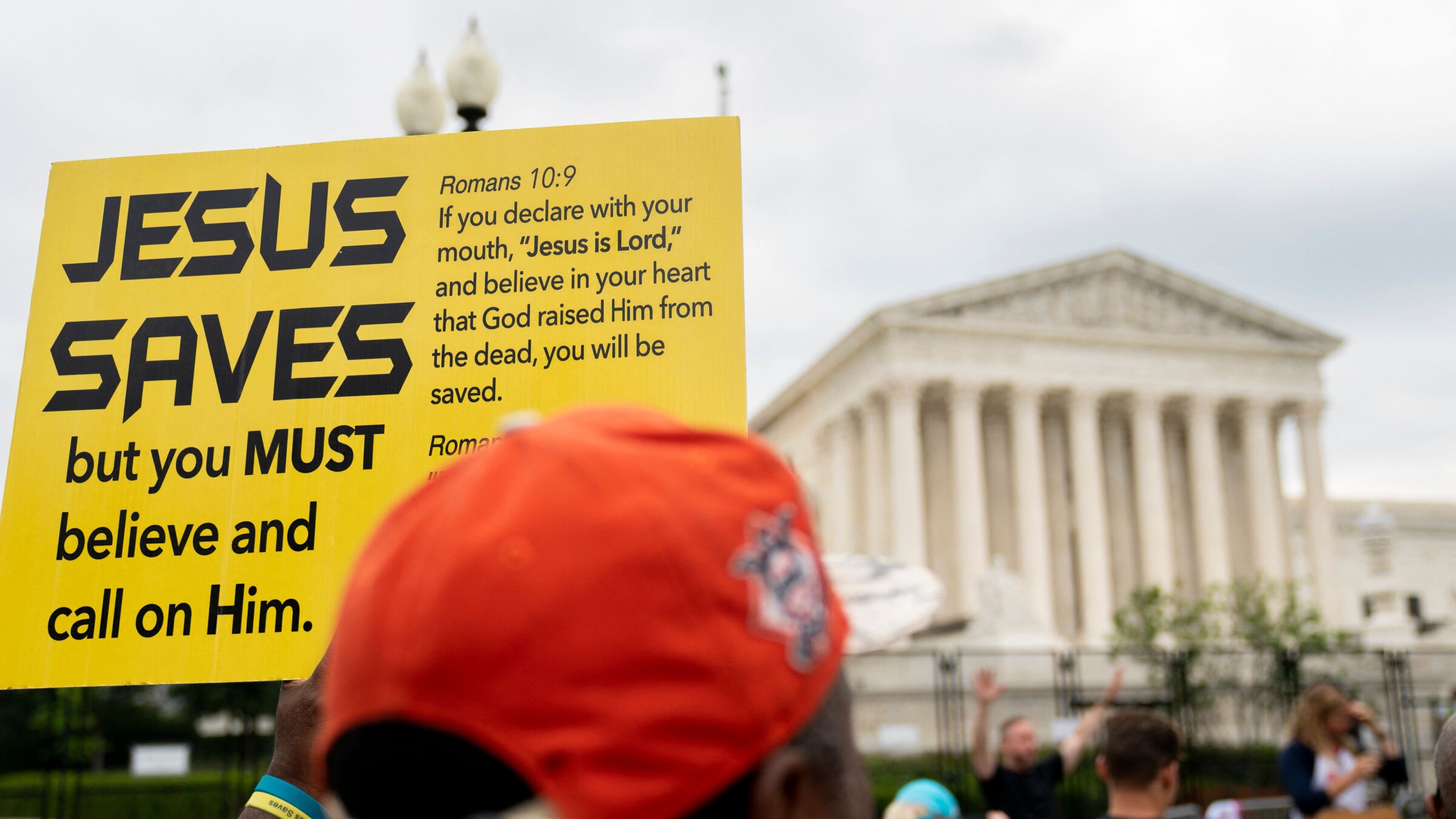 A person holds a Jesus Saves sign outside the U.S. Supreme Court in Washington, D.C., on June 27, 2022. STEFANI REYNOLDS/AFP via Getty Images