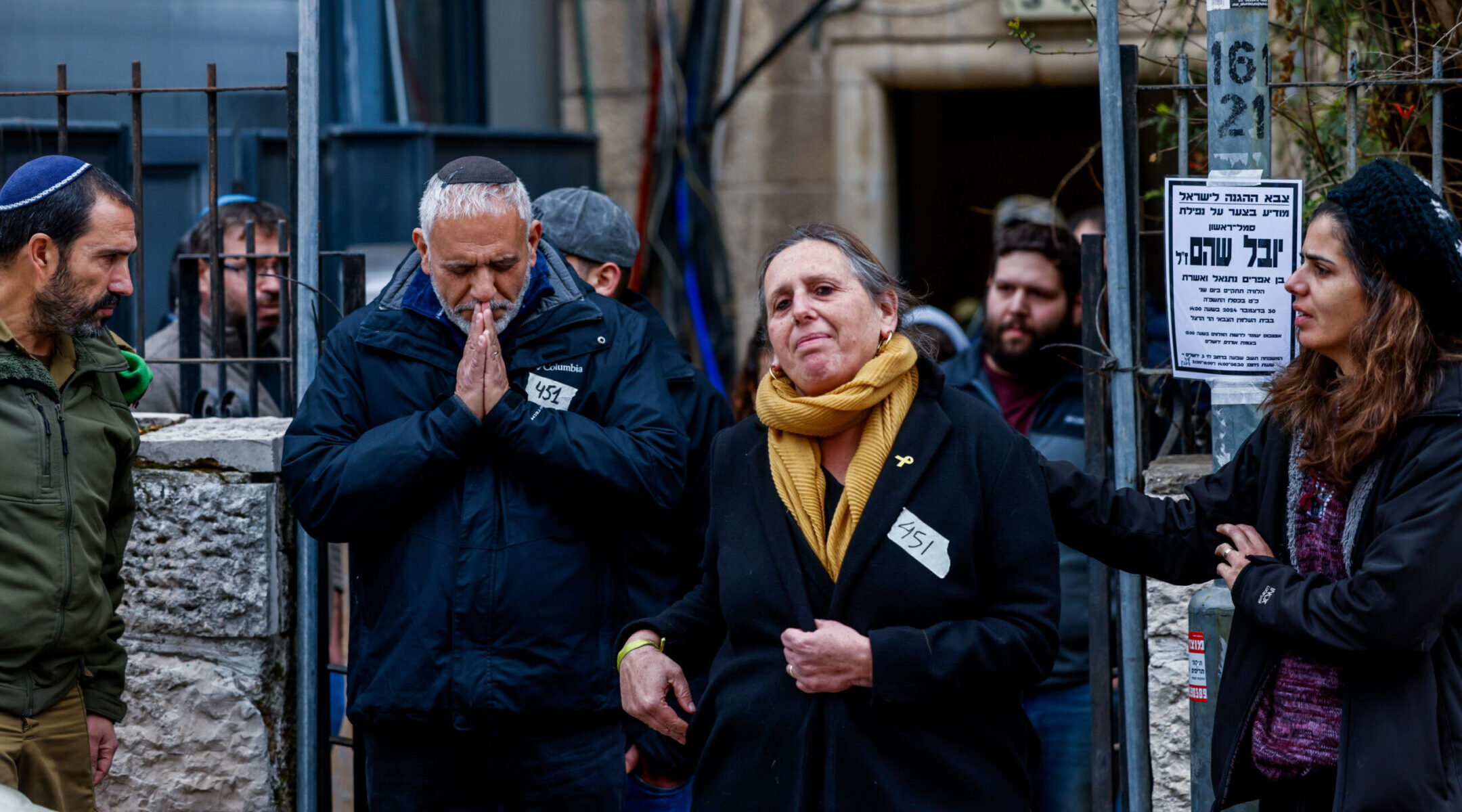 The parents of Yuval Shoham, who was killed in the Gaza Strip, leave their home for his funeral in Jerusalem, Dec. 30, 2024. (Chaim Goldberg/Flash90)