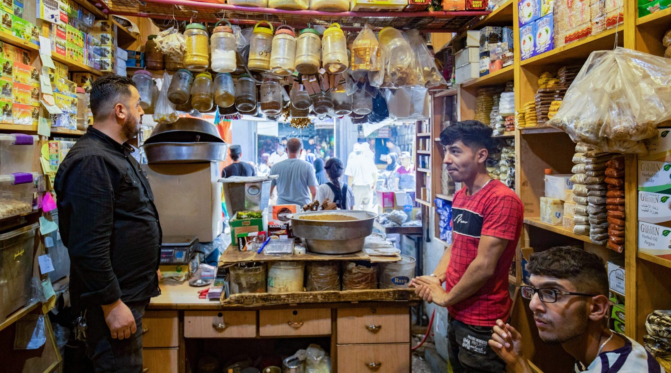 A shopkeeper helps a customer at the Azra Alyahoodi (Azra the Jew) market also known as the “Jewish market,” in the city of Qamishli in northeastern Syria, on July 27, 2023. (Photo by Delil Souleiman/AFP via Getty Images)