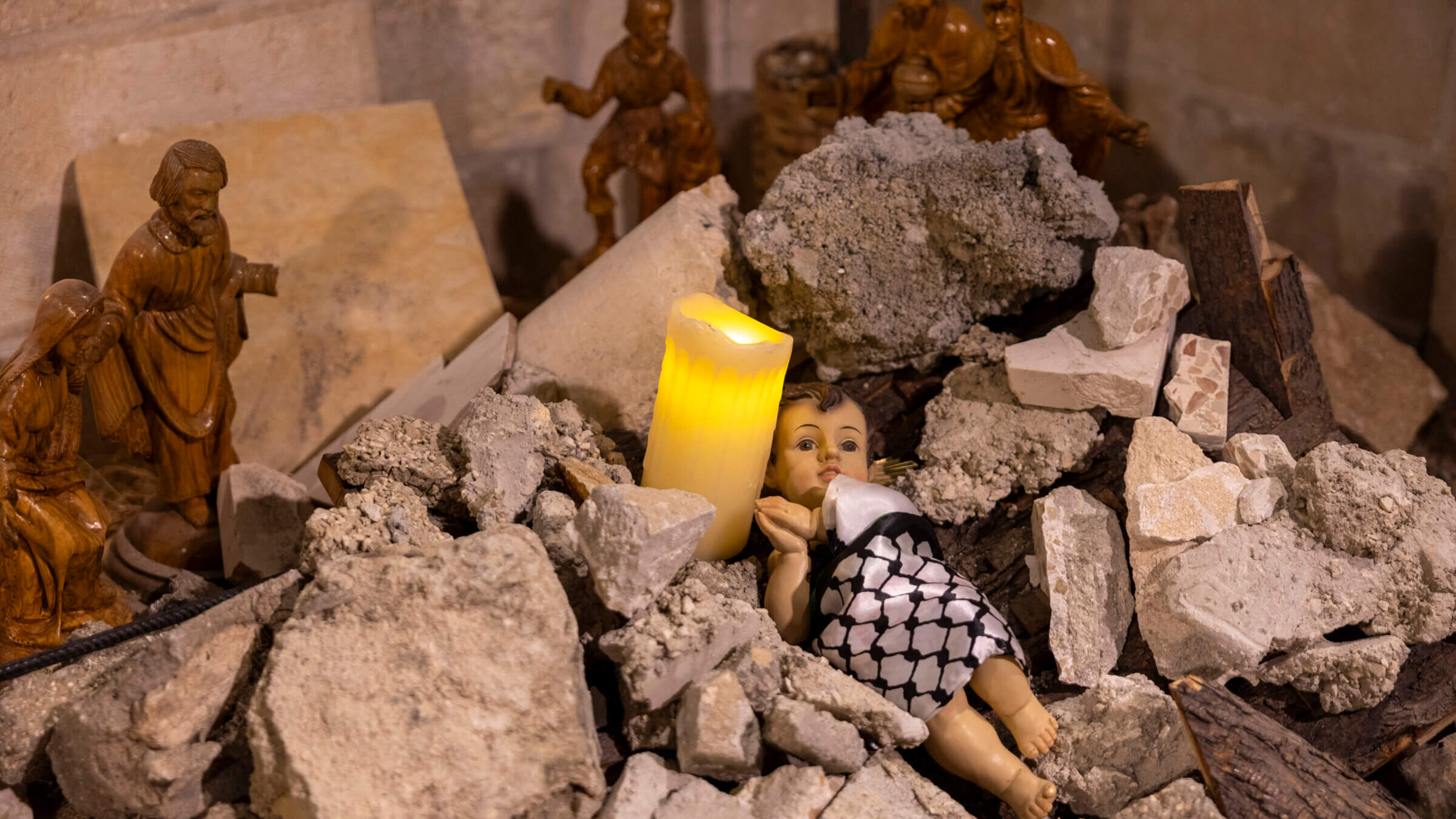 The Nativity scene shows baby Jesus wrapped in a keffiyeh and placed in a rubble to show solidarity with the people of Gaza on Dec. 24, 2023 in the Evangelical Lutheran Christmas Church in Bethlehem, West Bank. 