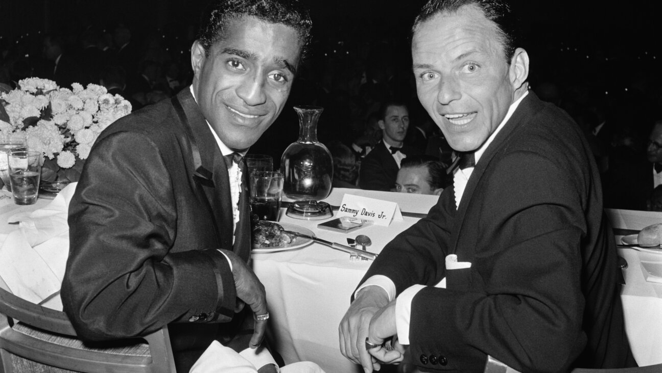 Sammy Davis Jr. and Frank Sinatra attend a dinner at the Friars Club, 1955.